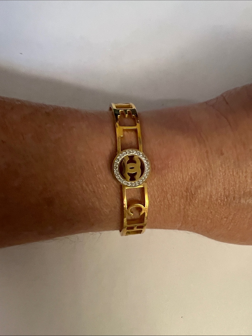 Gold Tone Inspired Logo Link Bracelet with Crystal Accent
